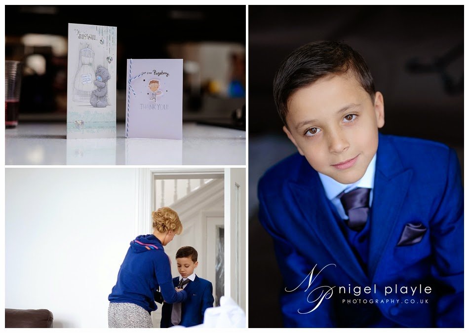 A boy in a blue suit is getting ready for his wedding photo.