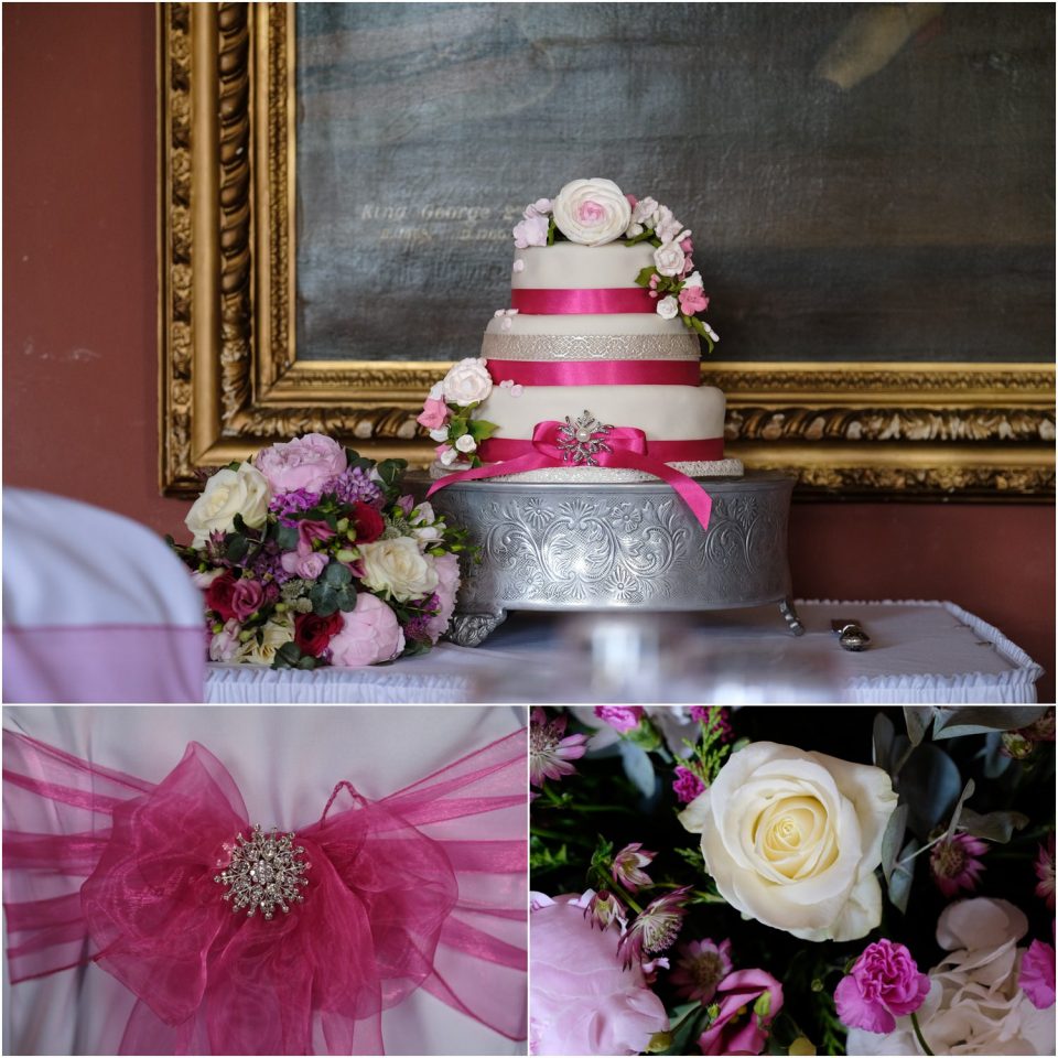 A wedding cake adorned with pink ribbons and flowers, captured beautifully in a wedding photo.