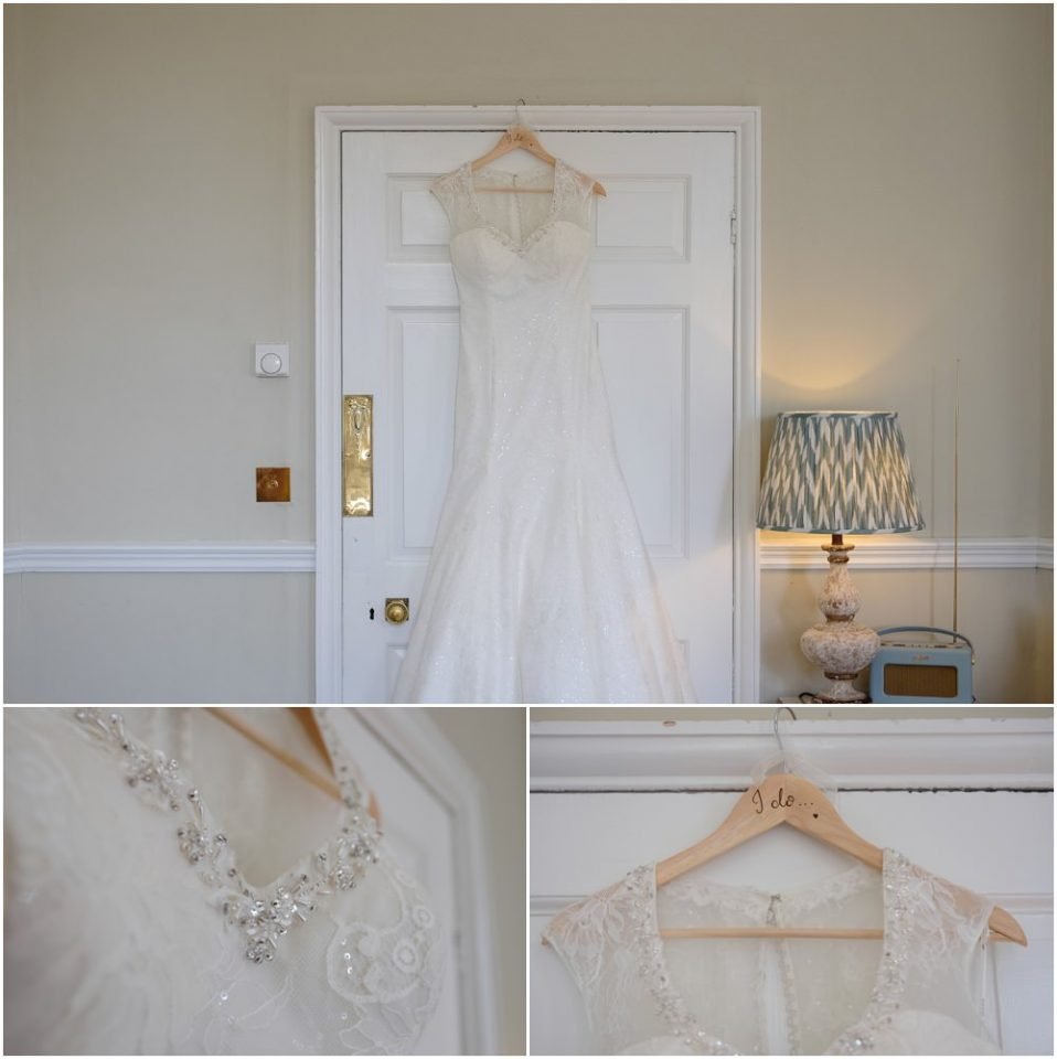 A beautiful wedding dress hangs gracefully on a hanger in front of a door, creating the perfect setting for a stunning wedding photograph.