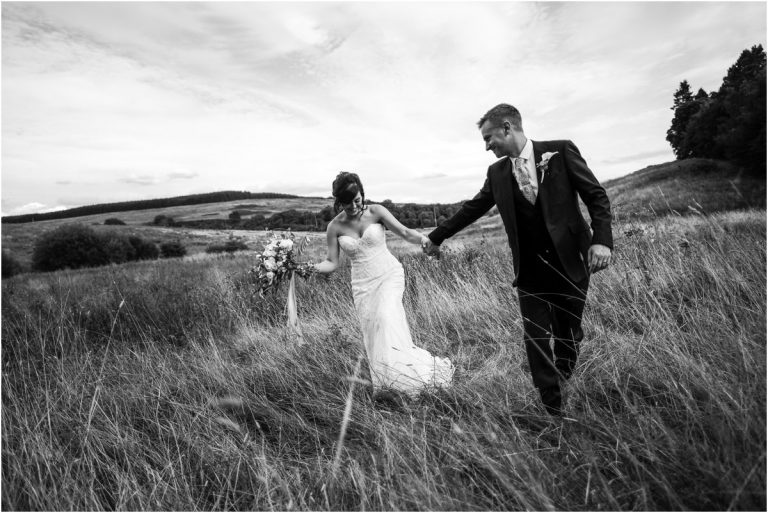 bride and groom in field