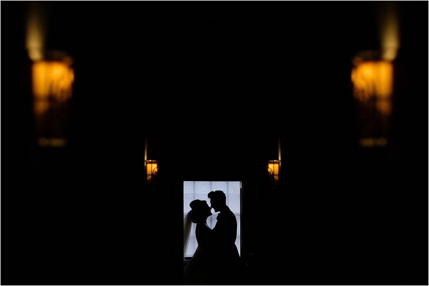bride and groom silhouette in window