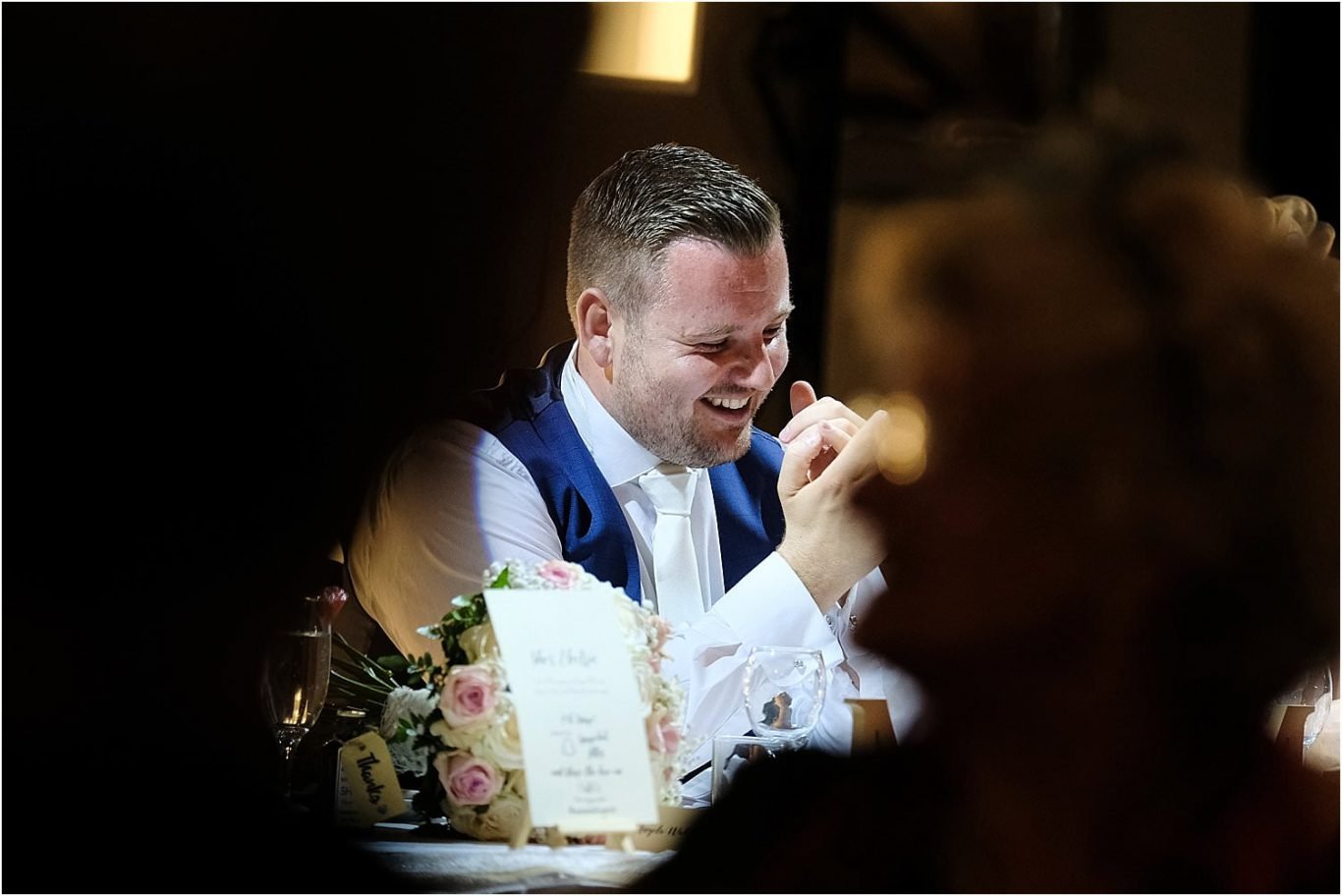 groom laughing during speeches