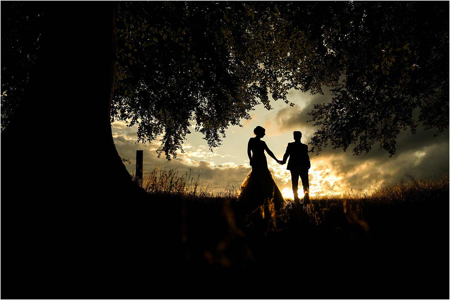 silhouette of bride and groom at sunset