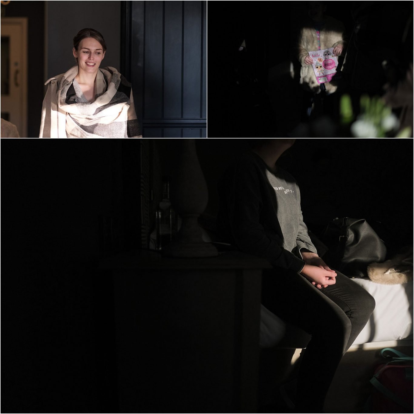 A woman is sitting in a dark room with a wedding photo.